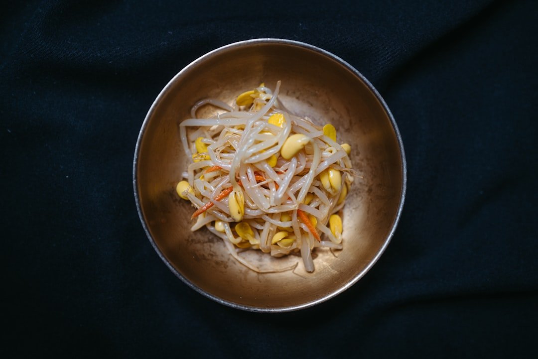 A bowl of garlic butter shrimp pasta garnished with fresh parsley and lemon wedge
