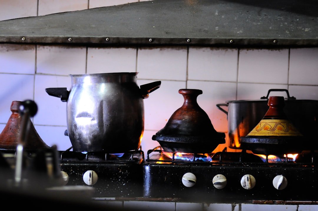 Split image showing a bubbling beef stew in a Dutch oven on the left and a colorful sheet pan with roasted chicken and vegetables on the right