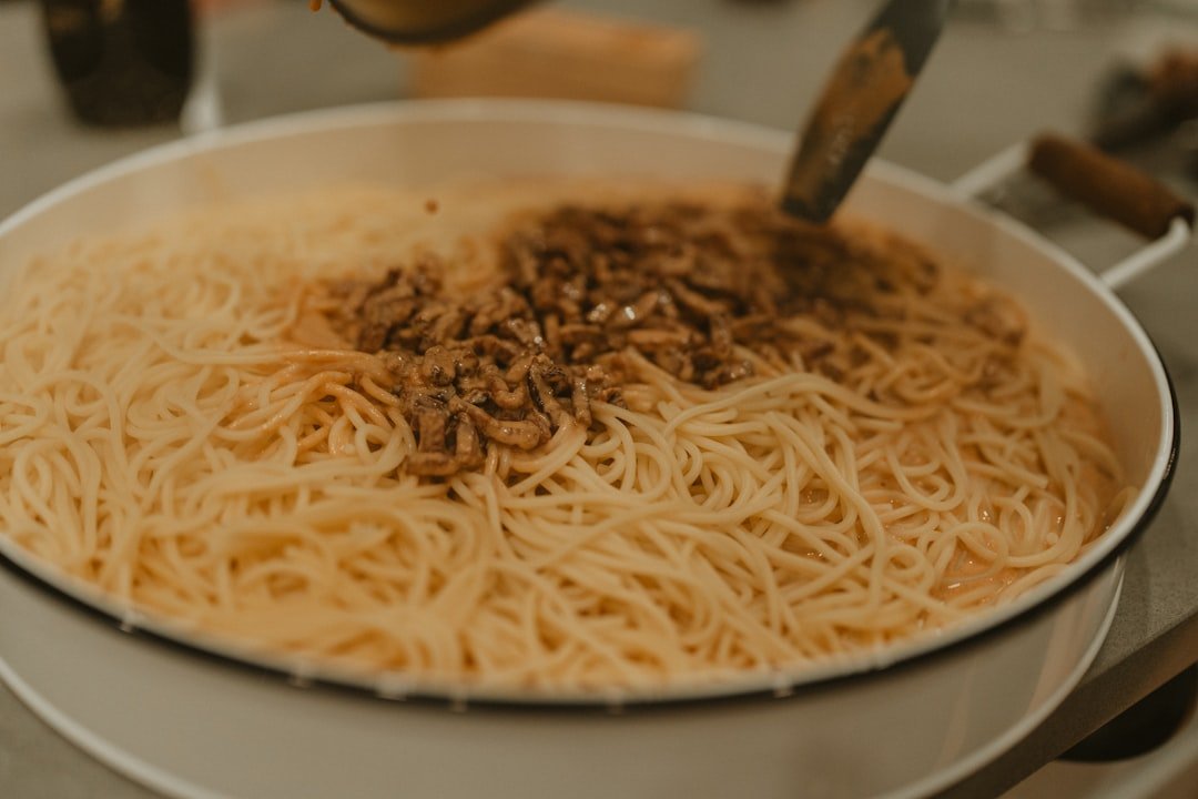 Bowl of spaghetti topped with hearty lentil bolognese sauce garnished with fresh basil